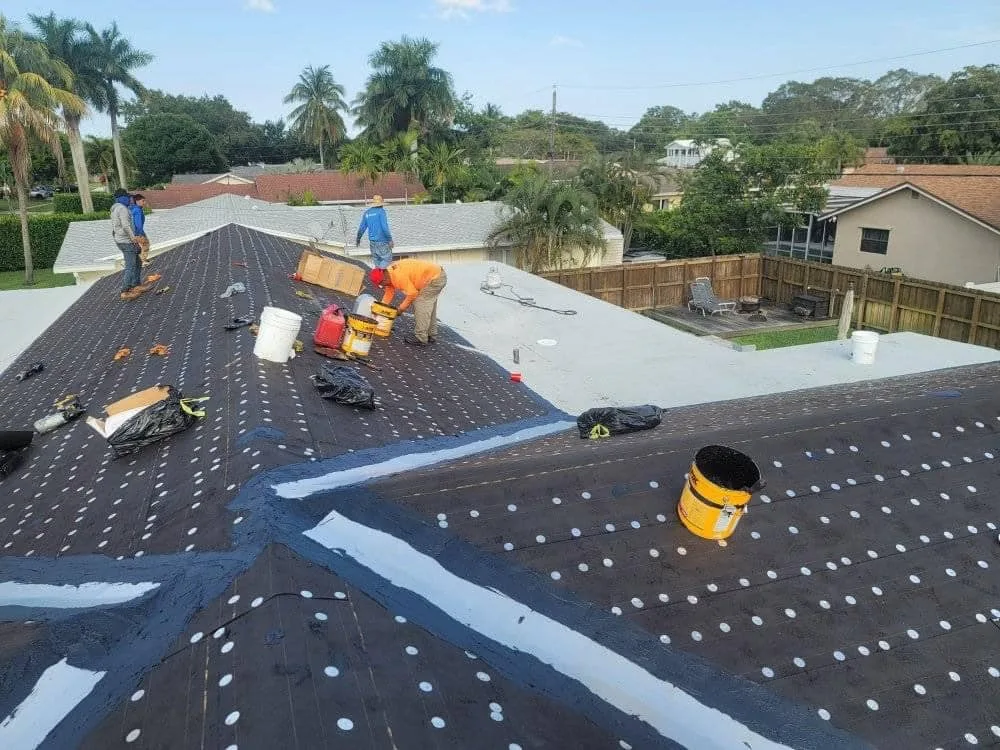 Flat roof base sheet installation by crew